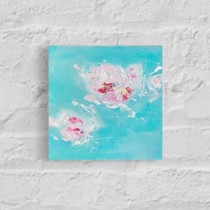 Abstract flower blossom painting on a white brick wall in pink against a blue background