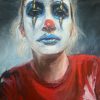 sad woman in a red jumper with her face painted as a clown