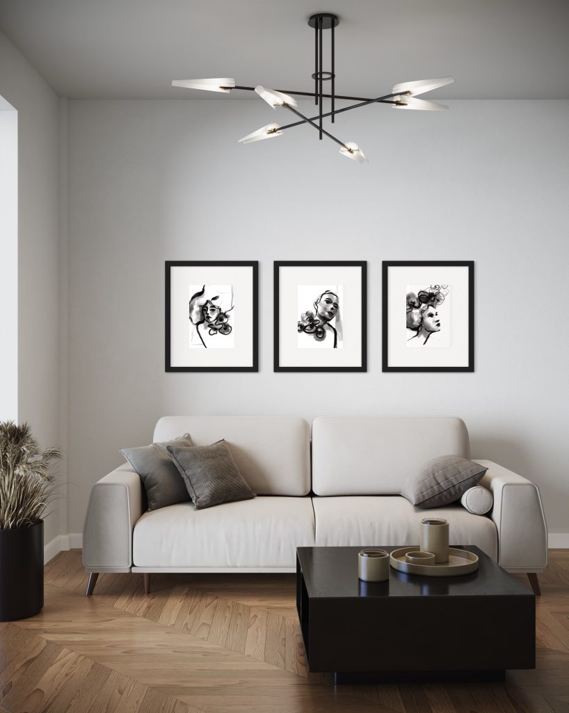 three art prints of women in black and white on a wall
