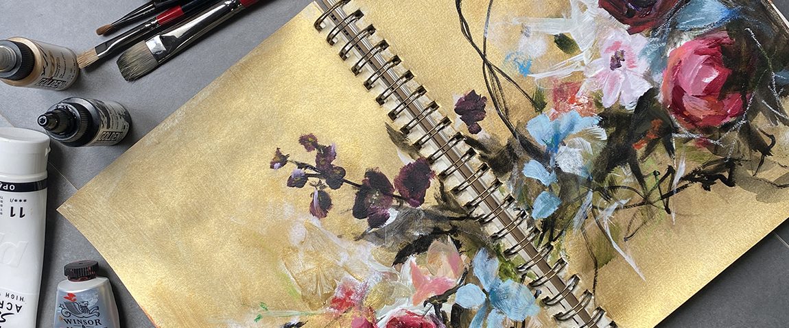 HERO SKETCHBOOK GOLD flowers painted in a sketchbook on a desk with art supplies
