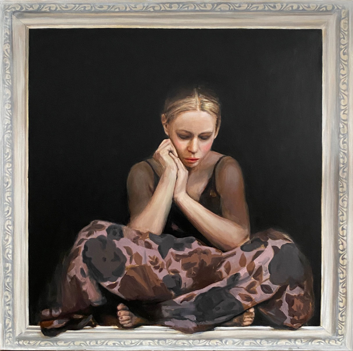 painted figure sat within a pichture frame